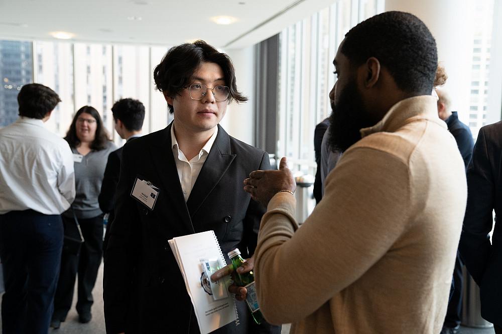A student and alumni talk together at the 2024 Business Networking Summit.