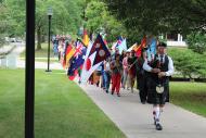 Beloit College kicks off the fall semester with a colorful parade that includes all the international flags of first-year students as they march down College Street to the convocation ceremonies at Eaton Chapel.